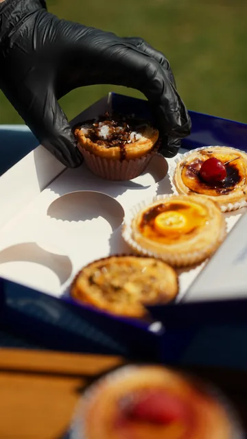 An open box of assorted Mostly Sunny custard tarts